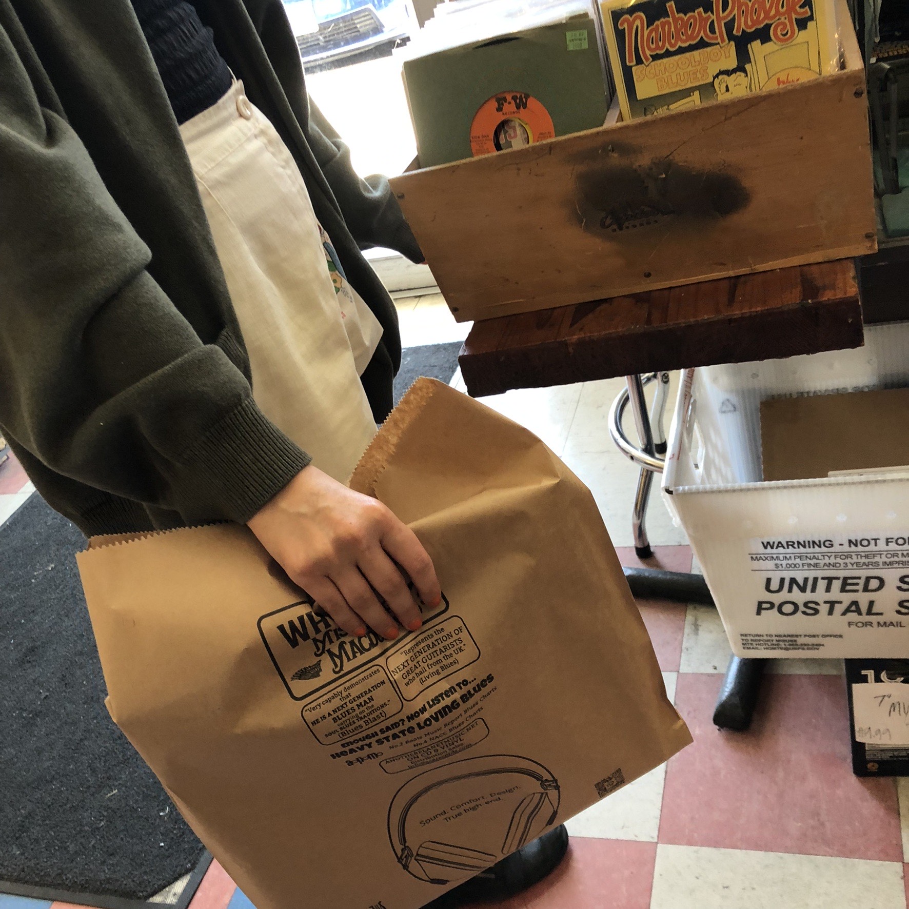 A printed campaign bag carried out of a record shop